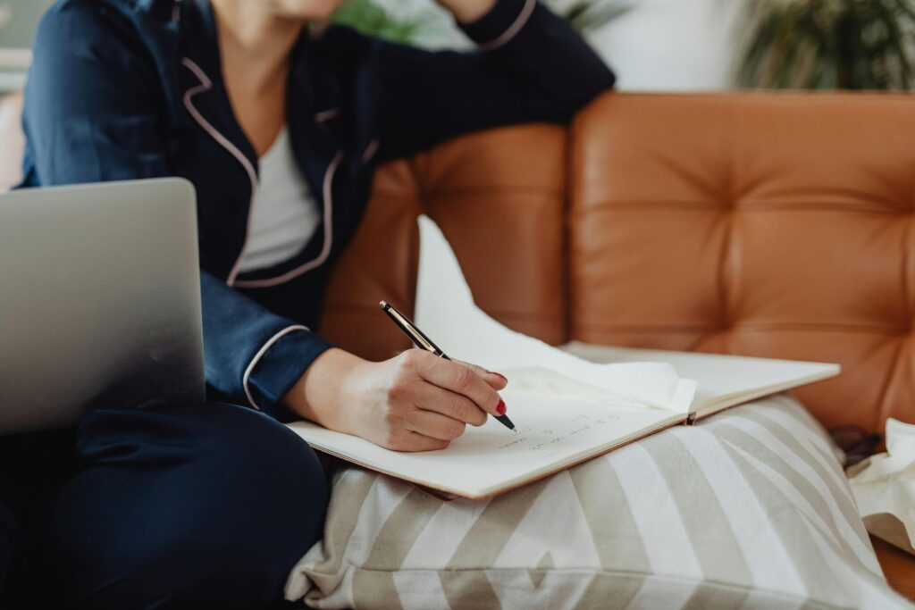 person writing in notebook